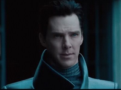 A Close Up Of A Man 'S Face With Blue Eyes And A Black Background GIF