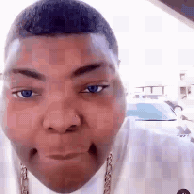 A Close Up Of A Man 'S Face With Blue Eyes And A Nose Ring . GIF
