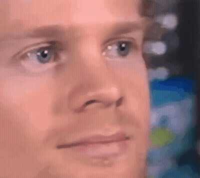 A Close Up Of A Man 'S Face With Blue Eyes And A Serious Look On His Face . GIF