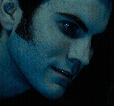 A Close Up Of A Man 'S Face With Blue Eyes GIF