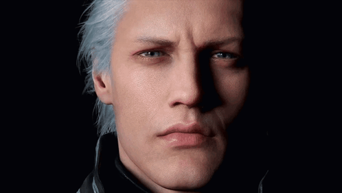 A Close Up Of A Man 'S Face With Blue Eyes GIF
