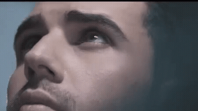 A Close Up Of A Man 'S Face With Blue Eyes Looking Up GIF