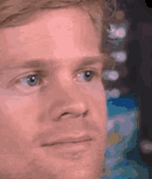 A Close Up Of A Man 'S Face With Blue Eyes Making A Funny Face . GIF