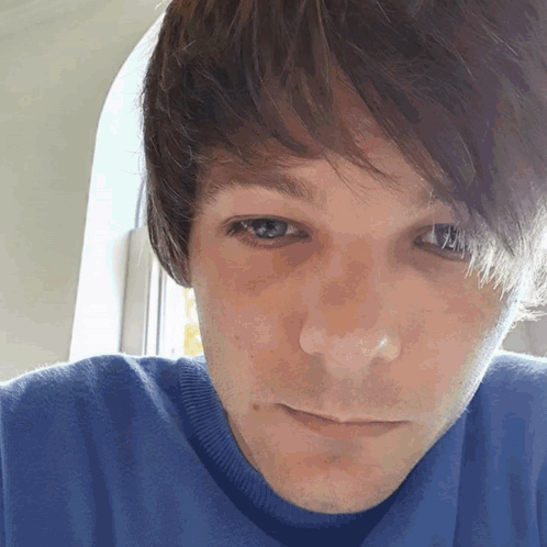 A Close Up Of A Man 'S Face With Blue Eyes GIF