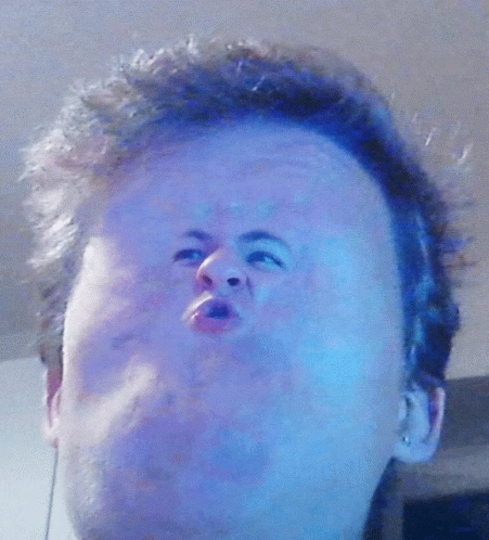 A Close Up Of A Man 'S Face With Blue Hair GIF