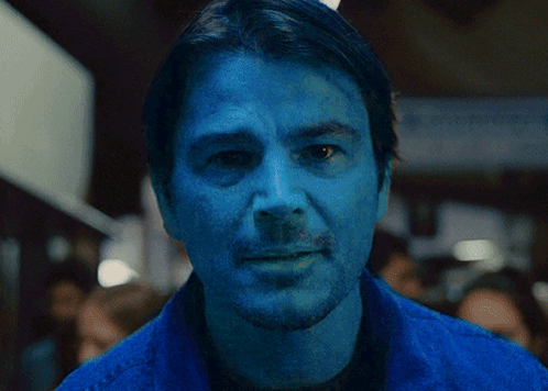 A Close Up Of A Man 'S Face With Blue Paint On It GIF