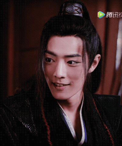 A Close Up Of A Man 'S Face With Chinese Writing On The Bottom Left GIF