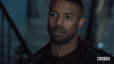 A Close Up Of A Man 'S Face With Creed Ii On The Bottom GIF