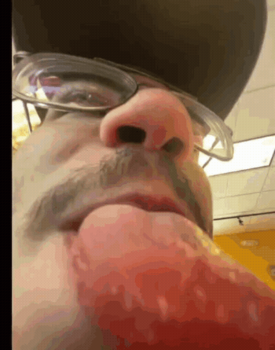 A Close Up Of A Man 'S Face With Glasses And A Hat On GIF