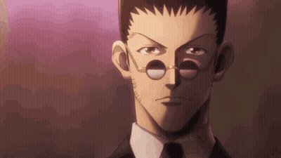 A Close Up Of A Man 'S Face With Glasses And A Tie . GIF