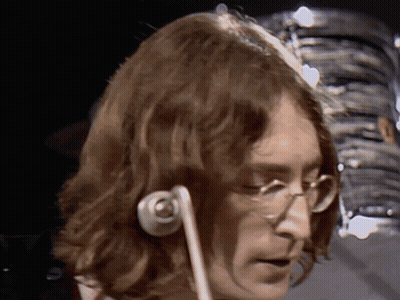 A Close Up Of A Man 'S Face With Glasses And Headphones GIF