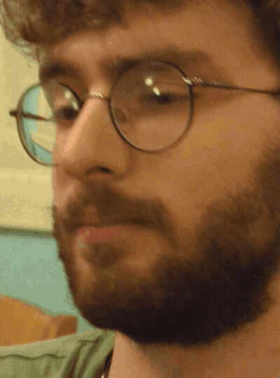 A Close Up Of A Man 'S Face With Glasses On GIF