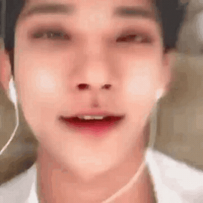 A Close Up Of A Man 'S Face With Headphones On . GIF