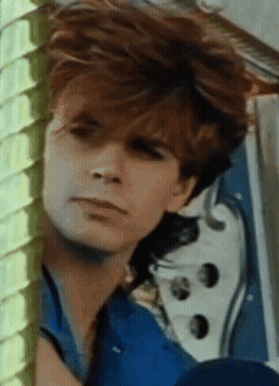 A Close Up Of A Man 'S Face With His Eyes Closed GIF