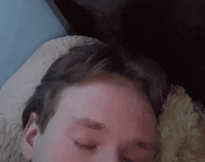 A Close Up Of A Man 'S Face With His Eyes Closed GIF