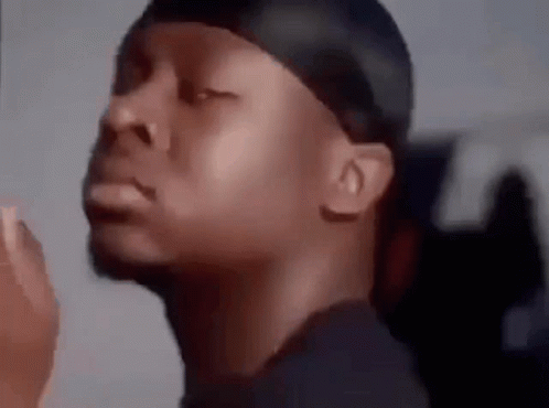 A Close Up Of A Man 'S Face With His Eyes Closed And A Bandana On His Head . GIF