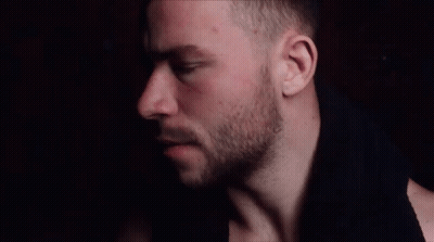 A Close Up Of A Man 'S Face With His Eyes Closed And A Beard GIF