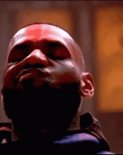 A Close Up Of A Man 'S Face With His Eyes Closed And A Beard . GIF