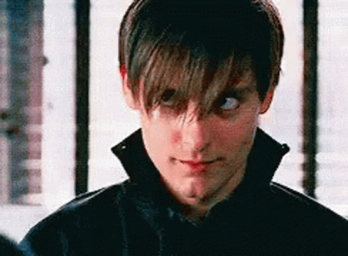 A Close Up Of A Man 'S Face With His Eyes Closed And A Black Jacket On . GIF