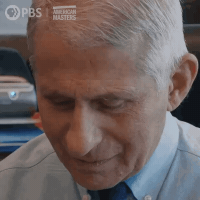 A Close Up Of A Man 'S Face With His Eyes Closed And A Blue Shirt And Tie . GIF