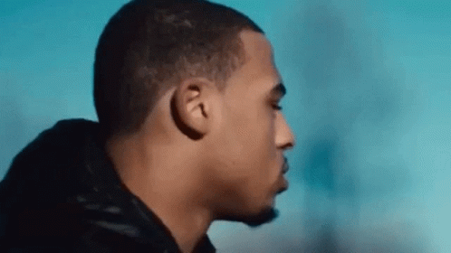A Close Up Of A Man 'S Face With His Eyes Closed And A Blue Sky In The Background . GIF