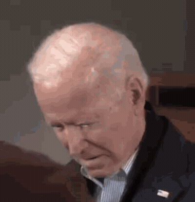 A Close Up Of A Man 'S Face With His Eyes Closed And A Lapel Pin . GIF