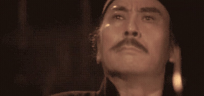 A Close Up Of A Man 'S Face With His Eyes Closed And A Mustache GIF