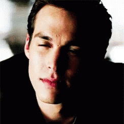 A Close Up Of A Man 'S Face With His Eyes Closed And A Shadow On His Face . GIF