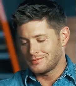 A Close Up Of A Man 'S Face With His Eyes Closed And A Smile On His Face . GIF