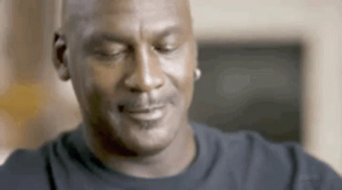 A Close Up Of A Man 'S Face With His Eyes Closed And A Smile On His Face . GIF