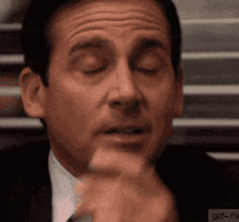 A Close Up Of A Man 'S Face With His Eyes Closed And His Hand On His Chin . GIF