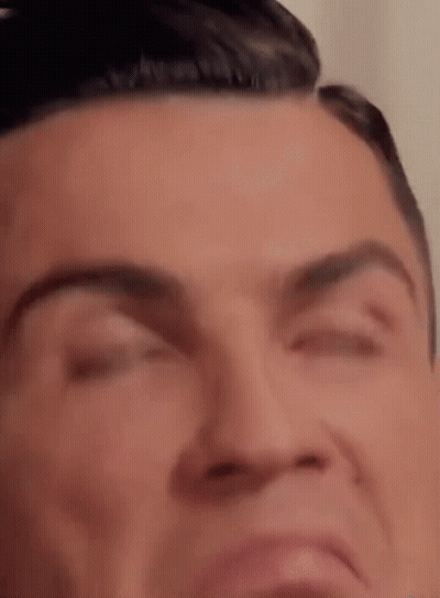 A Close Up Of A Man 'S Face With His Eyes Closed And His Mouth Open . GIF
