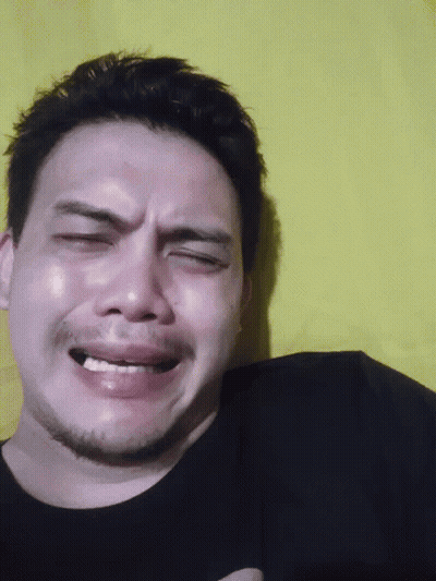 A Close Up Of A Man 'S Face With His Eyes Closed And His Mouth Open GIF