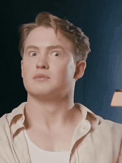 A Close Up Of A Man 'S Face With His Eyes Closed And His Mouth Open . GIF