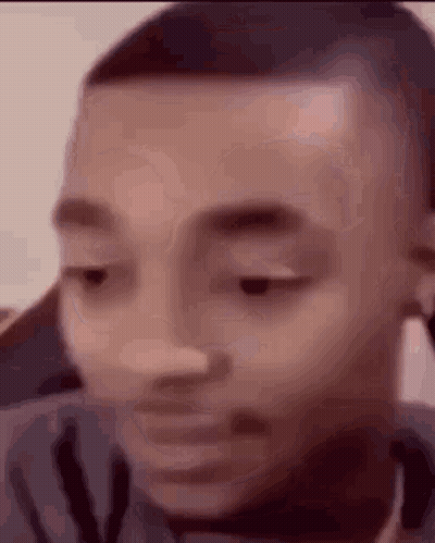 A Close Up Of A Man 'S Face With His Eyes Closed And His Mouth Open . GIF