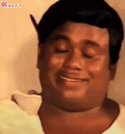 A Close Up Of A Man 'S Face With His Eyes Closed And Smiling . GIF