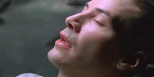 A Close Up Of A Man 'S Face With His Eyes Closed And Sweat Coming Out Of His Nose . GIF