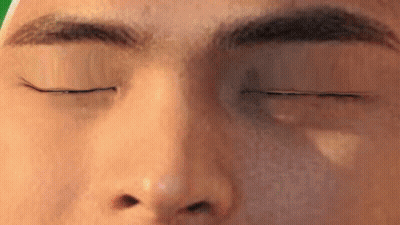 A Close Up Of A Man 'S Face With His Eyes Closed GIF