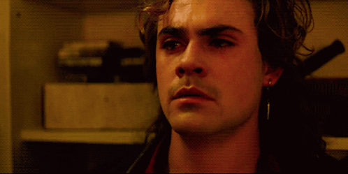 A Close Up Of A Man 'S Face With His Eyes Closed In A Dark Room GIF
