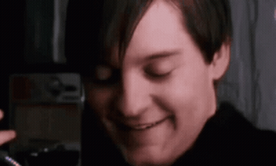 A Close Up Of A Man 'S Face With His Eyes Closed Smiling . GIF