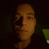 A Close Up Of A Man 'S Face With His Eyes Looking At The Camera GIF