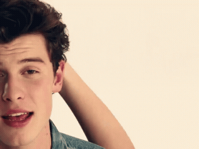 A Close Up Of A Man 'S Face With His Hand In His Hair GIF
