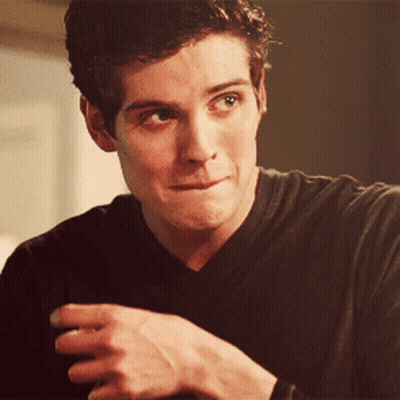 A Close Up Of A Man 'S Face With His Hand On His Chin GIF