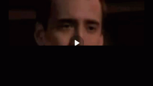 A Close Up Of A Man 'S Face With His Hand On His Mouth . GIF
