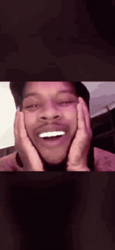 A Close Up Of A Man 'S Face With His Hands On His Face And His Mouth Open . GIF