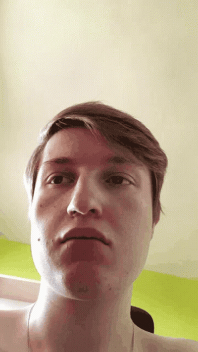 A Close Up Of A Man 'S Face With His Mouth Open GIF