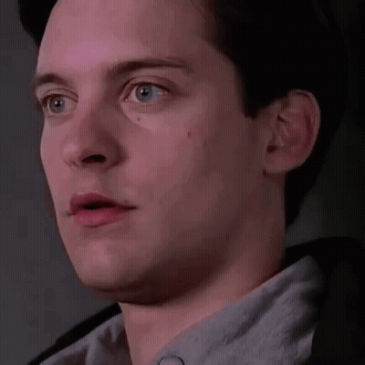 A Close Up Of A Man 'S Face With His Mouth Open And A Gray Shirt On . GIF