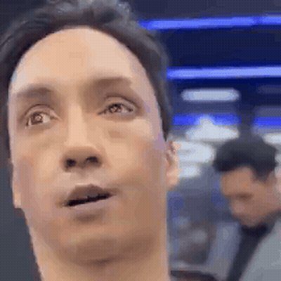 A Close Up Of A Man 'S Face With His Mouth Open And A Man In The Background . GIF