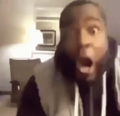 A Close Up Of A Man 'S Face With His Mouth Open And A Surprised Look On His Face . GIF