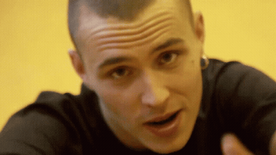 A Close Up Of A Man 'S Face With His Mouth Open And A Yellow Background GIF